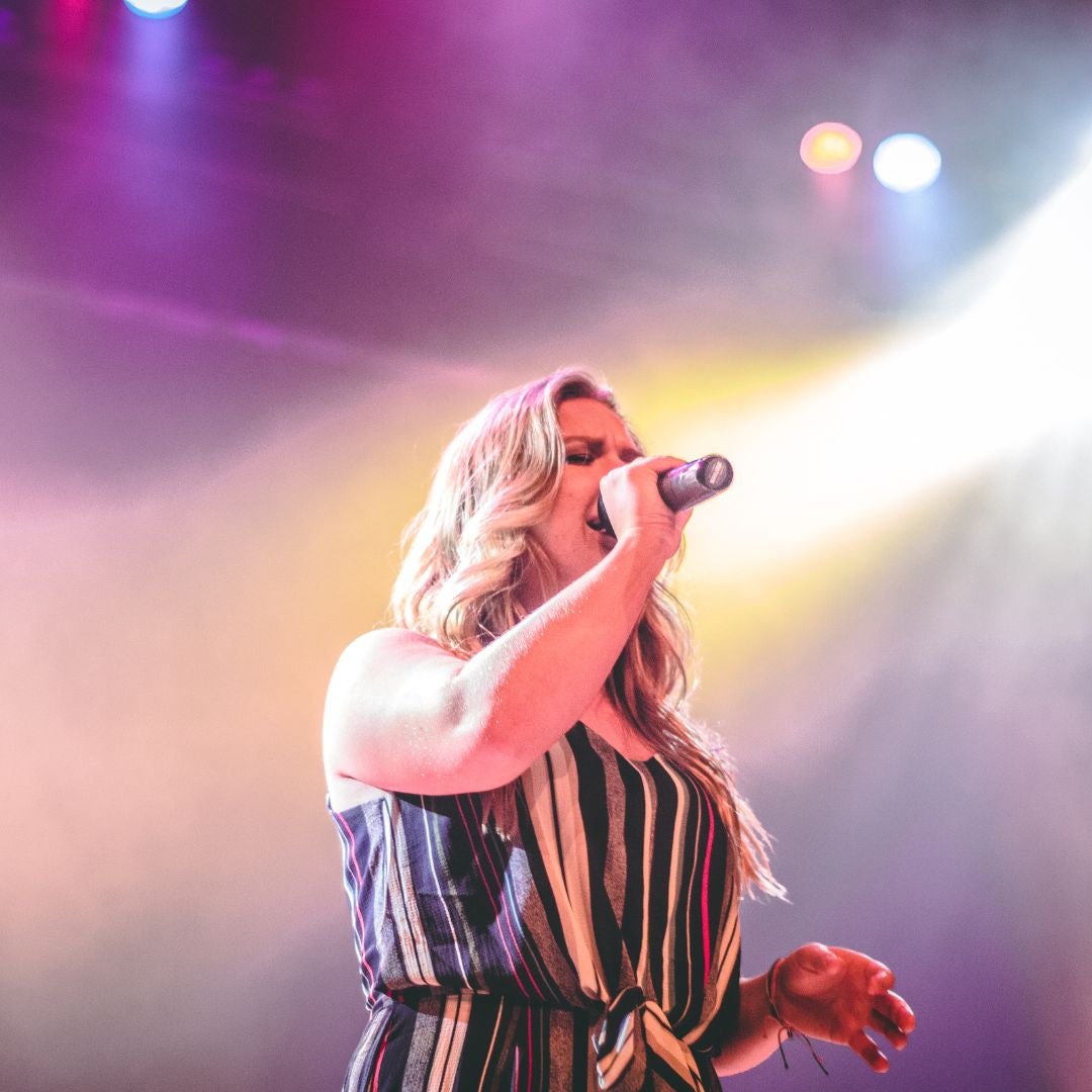 a woman singing on stage